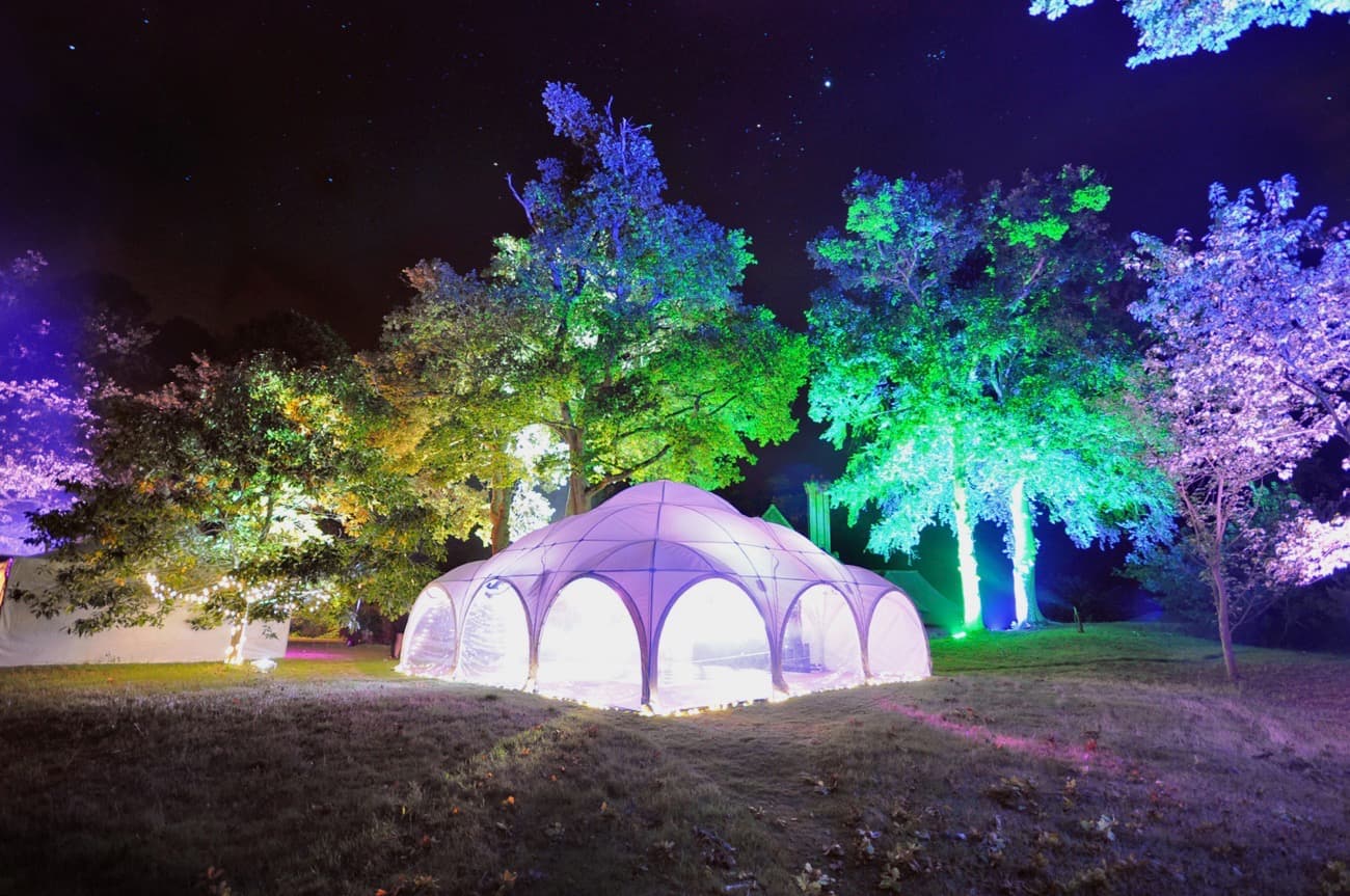 dome marquee floodlit in woods