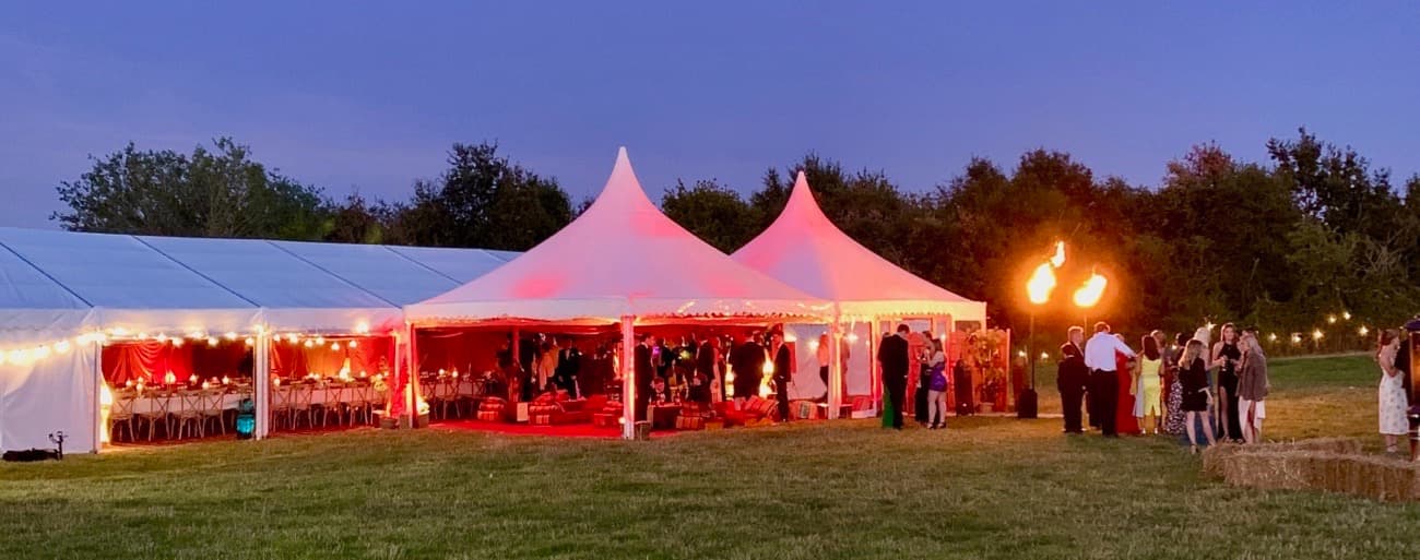 Party Marquee at dusk with flames at the entrance