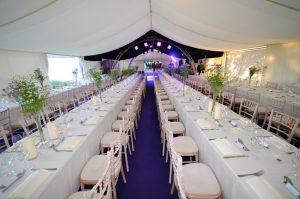 Trestle tables in a marquee laid up for a 21st party dinner