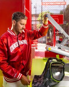 NBA player Dragic in a red Hennessy jacket using a heat press personalise NBA jerseys for Hennessy.