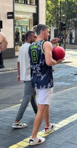 NBA player Goran Dragić holding a basketball wearing a personalised Hennessy jersey.