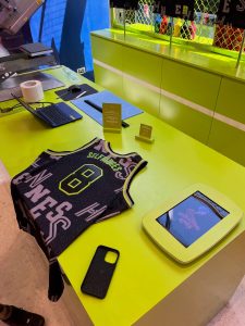 A NBA basketball jersey on a desk, personalised with the word "Selfridges."