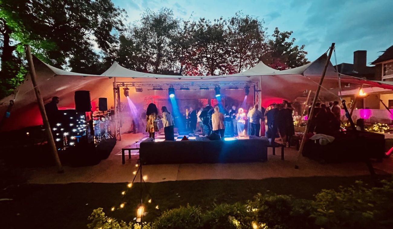 People dancing in a stretch marquee for a 40th birthday party in a garden