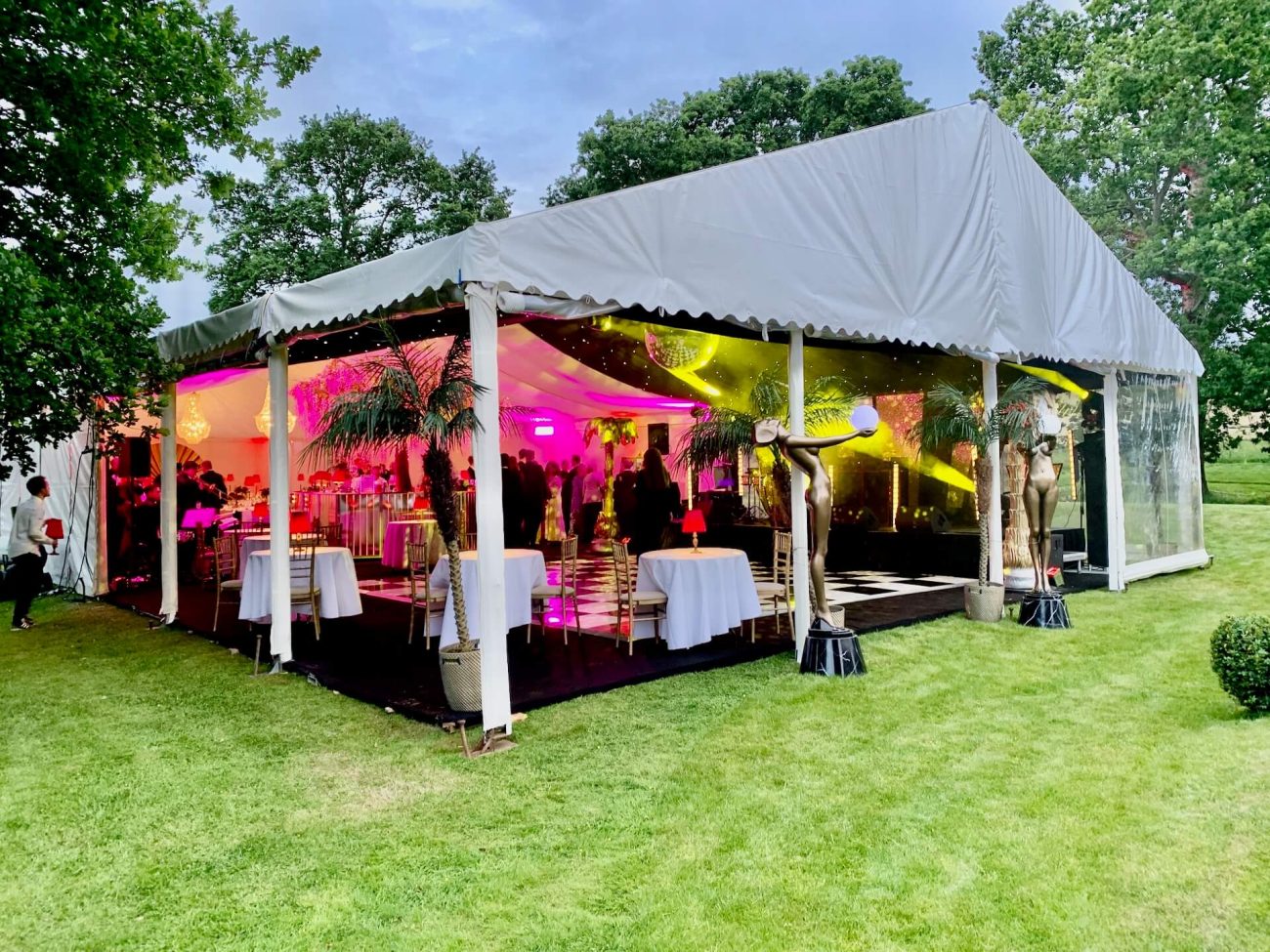 Marquee on a grass tennis court ready for a 1920's themed party.
